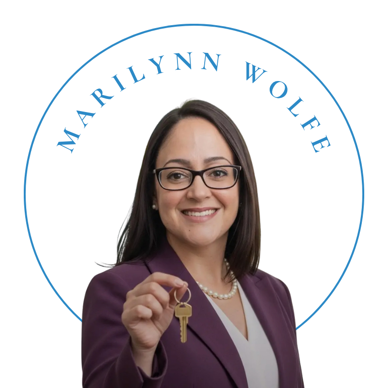 Professional headshot of Marilynn Wolfe, Florida Realtor, holding a gold key and smiling representing trusted real estate service and coastal luxury living.